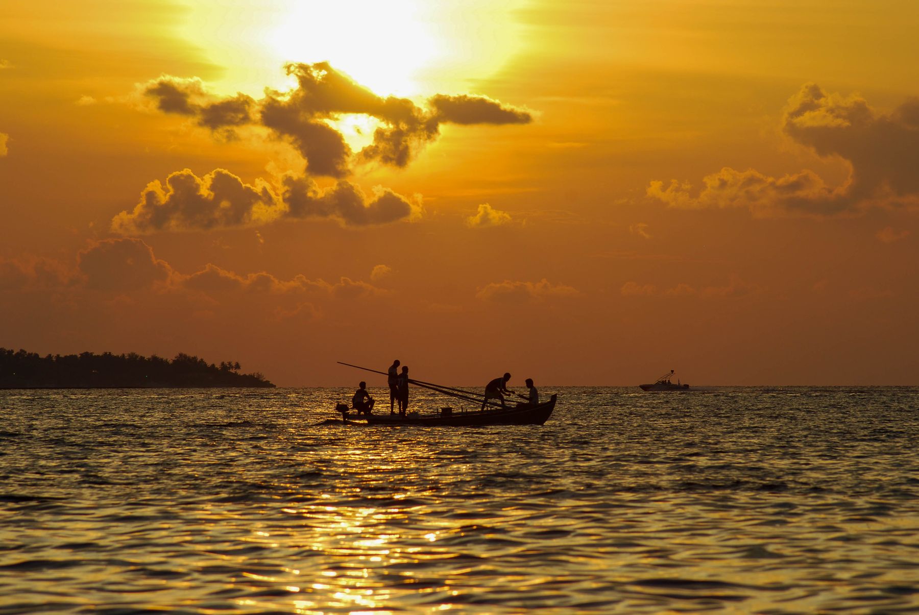 A traditional Maldivian dhoni at sunset